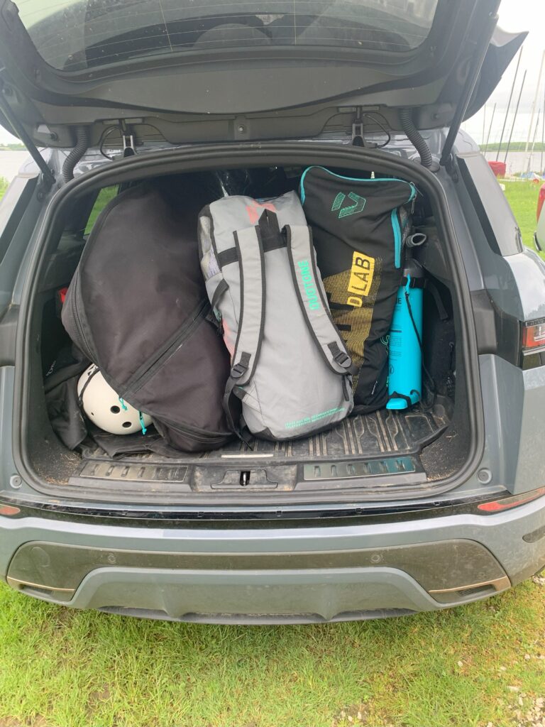 Medium size SUV loaded with wing foiling board, foil and multiple wings showing how compact the gear is one of the reasons why people start wing foiling