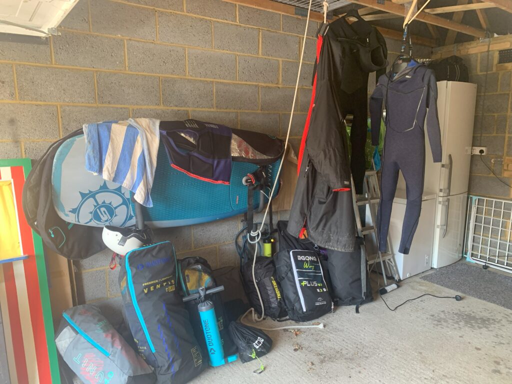 Illustrating a garage where a significant amount of wing foiling gear has been purchased and stored