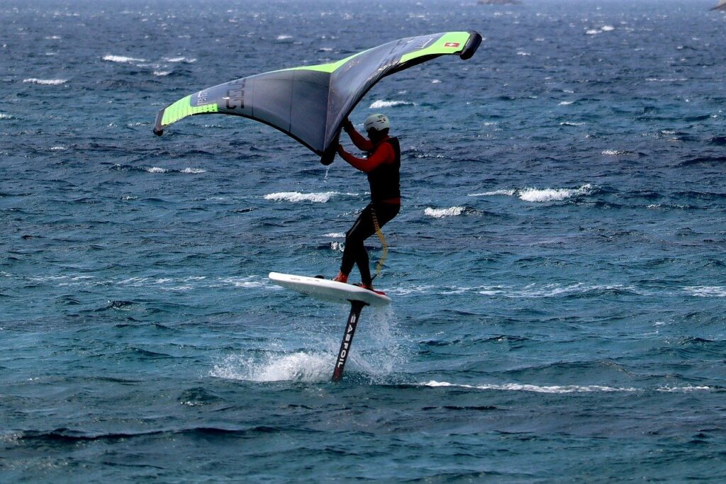 Wing foiler flying high over the sea