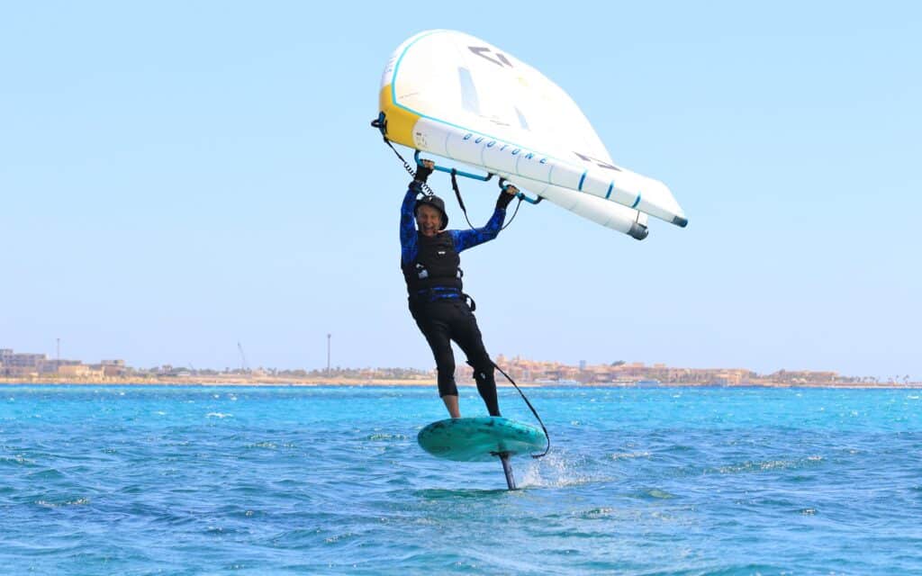 A happy wing foiler smiling as he enjoys the amazing conditions