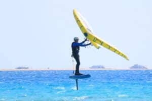 A wingfoiler gliding over the blue waters of Soma Bay egypt